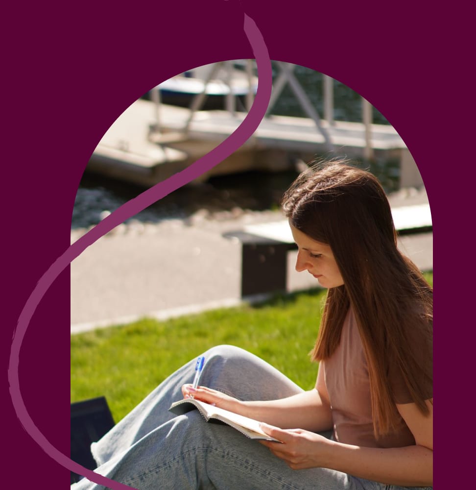 Image of Natalie reading outside in the park